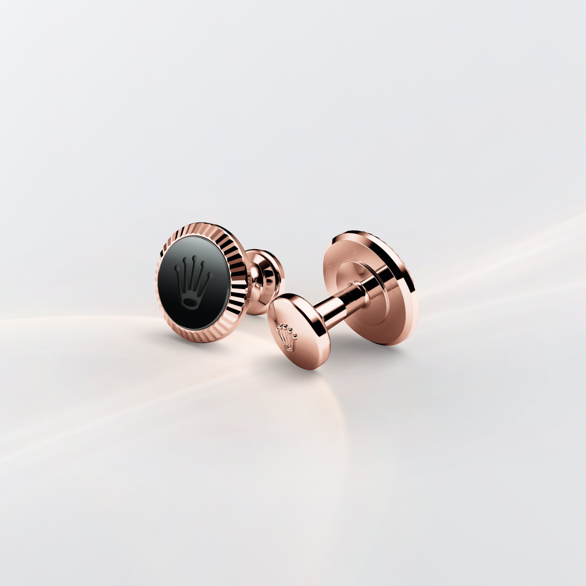 Rolex cufflinks made of 18 ct Everose gold featuring the signature Rolex fluting, Cerachrom insert and Rolex crown.